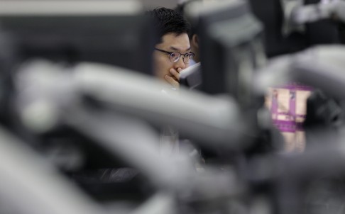 A currency trader in Asia keeps an eye on exchange rate as the market share of China currency in the global payment system increased to its highest level in four months