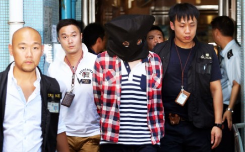 The suspect is led away by police yesterday