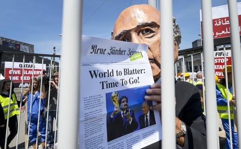 A demonstrator disguised as Fifa President Sepp Blatter takes part in a protest against the condition of workers in Qatar in Zurich